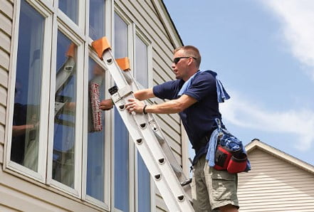 Cloute Inc team member washing windows