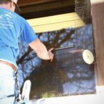 professional window cleaner washing exterior glass on a Madison, Wisconsin home