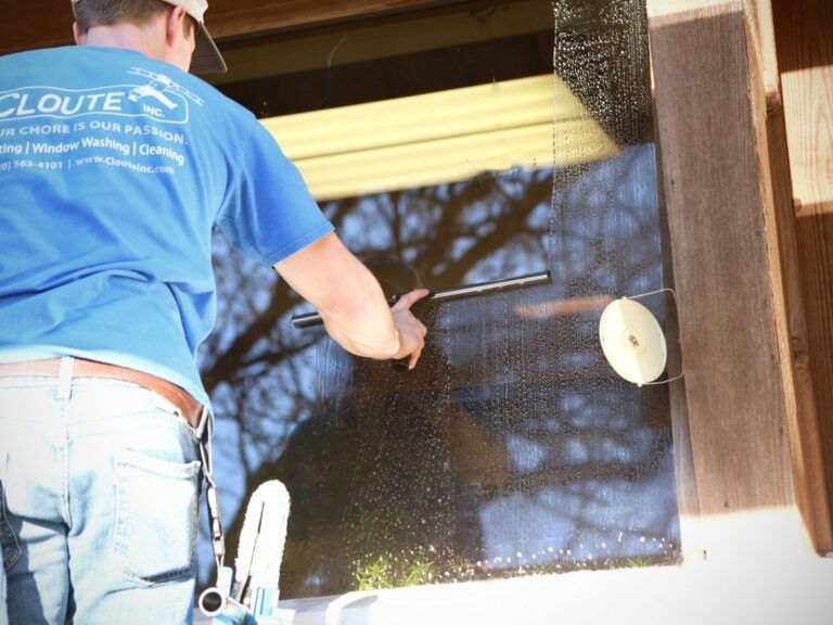 professional window cleaner washing exterior glass on a Madison, Wisconsin home